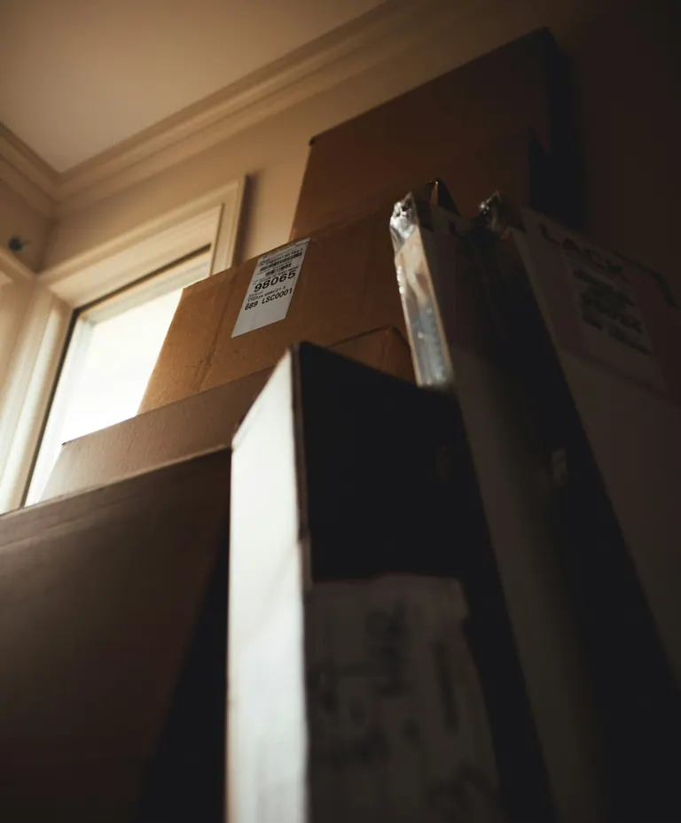 Flat-pack furniture boxes stacked ready for unpacking and assembly.